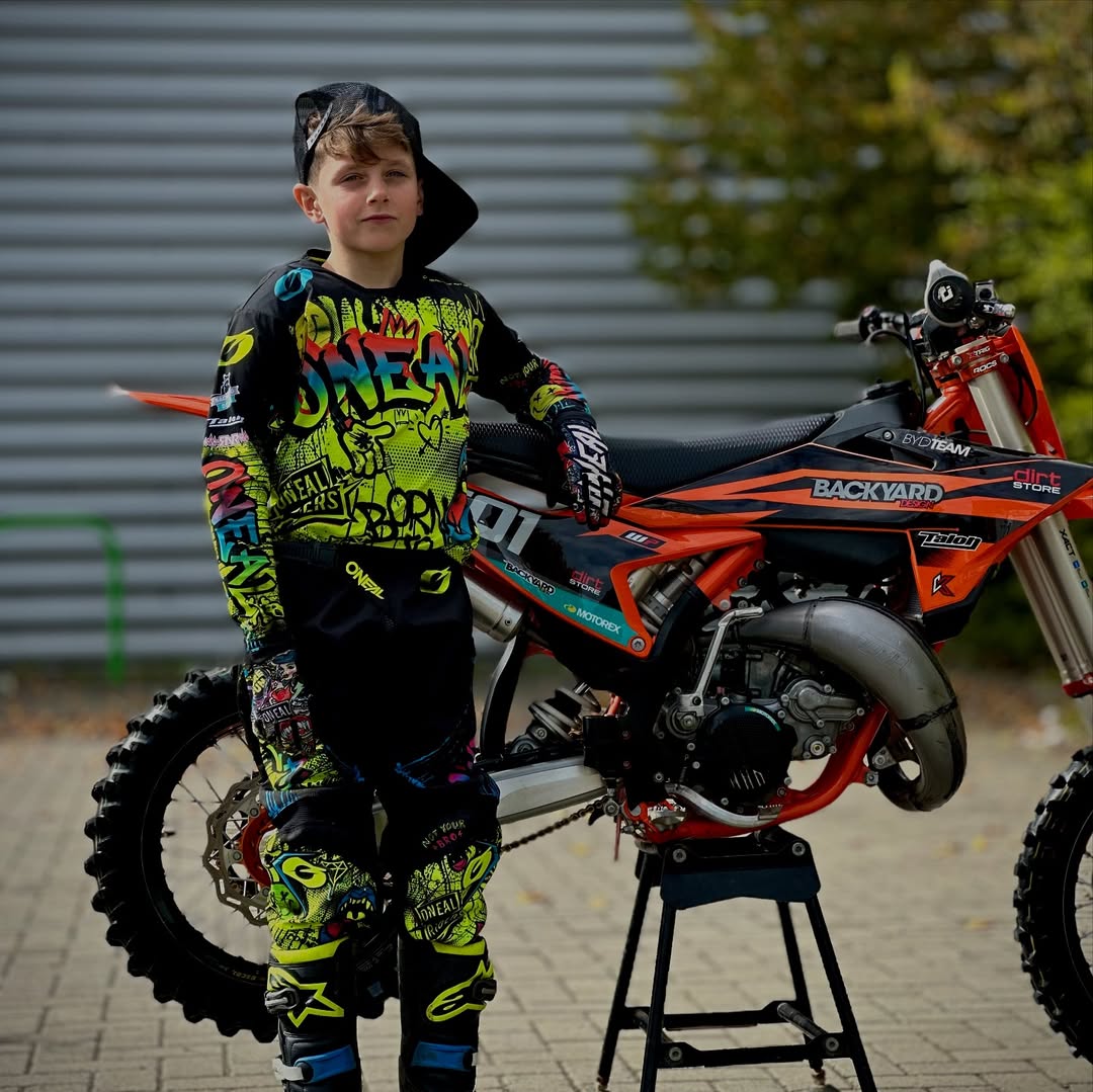 Pro motocross youth rider Austin Edwards wearing neon custom jersey with logos